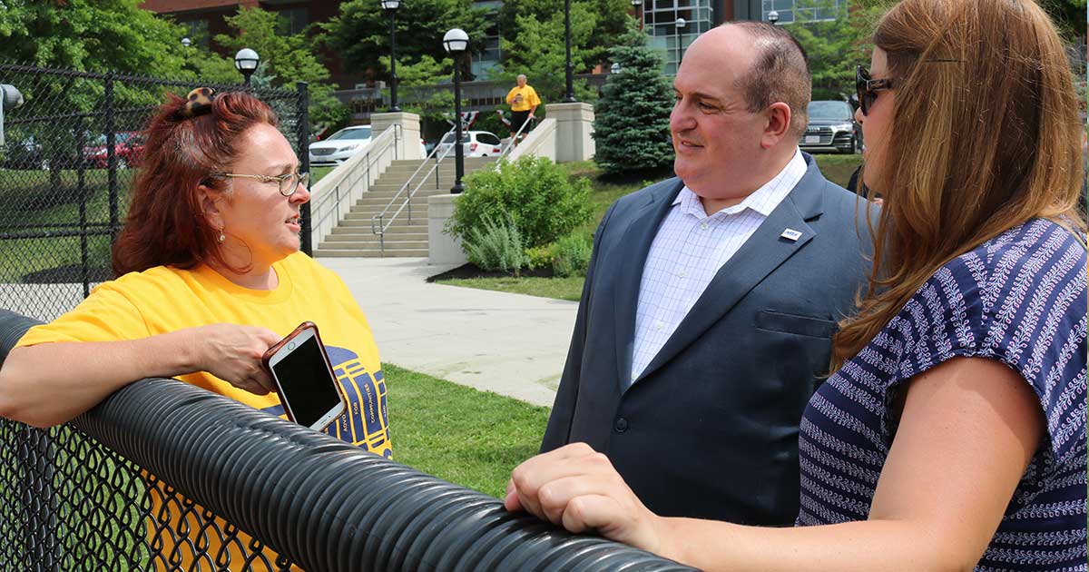 MTA Vice President Erik J. Champy speaks with Everett Teachers Association President Kim Auger, left, and Jennifer Cuthbert, a teacher and parent from Everett.