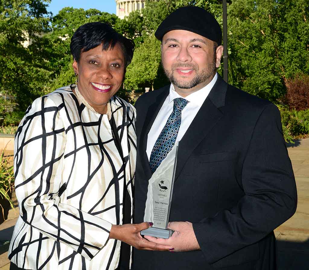 NEA Vice President Becky Pringle presented the RISE award to Worcester paraeducator Saul Ramos, the national ESP of the Year.