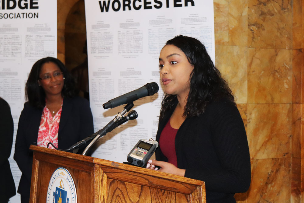 Anabel Santiago, a student at UMass Dartmouth and a graduate of Massachusetts public schools, said that rising tuition and fees have made public higher education “no longer affordable for middle- and working-class students.” Greenfield Community College President Yves Salomon-Fernández looked on as Santiago spoke.