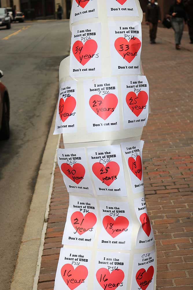 Hearts represented laid-off UMass Boston workers, and each worker’s years of service to the campus, on a sign at the demonstration.