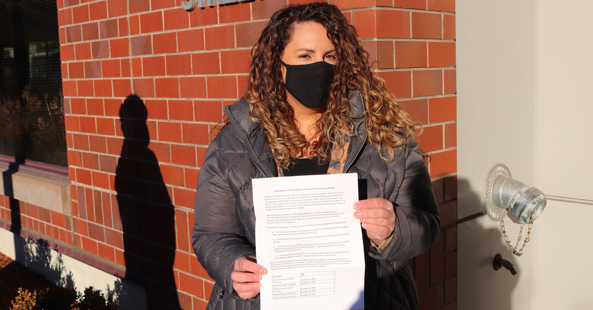 Malden Education Association President Deborah Gesualdo with the petition.